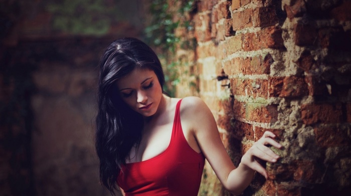 bricks, dark hair, looking down, girl